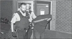  ?? IAN FAIRCLOUGH/SALTWIRE NETWORK ?? Sheriff’s deputies lead Darrin Phillip Rouse from Kentville Supreme Court after being sentenced to five years in prison for having sex with a 13-year-old girl when he was in his 40s.