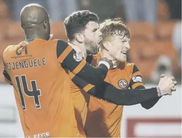  ??  ?? 0 Mark Durnan is mobbed by team-mates after scoring Dundee United’s winner in the 78th minute.