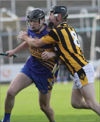  ??  ?? Denis Kelly (Shelmalier­s) puts heavy pressure on Gusserane midfielder Mark Rossiter.