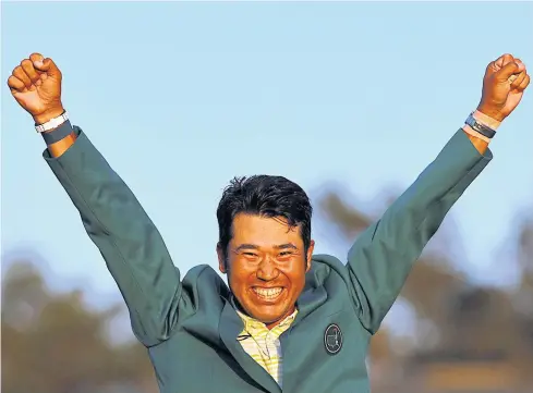  ?? REUTERS ?? Hideki Matsuyama celebrates with his green jacket after winning the Masters at Augusta National on Sunday.