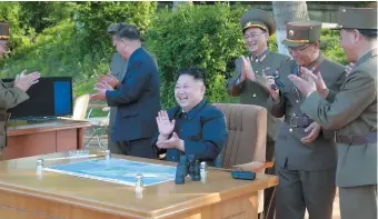  ??  ?? North Korean leader Kim Jong-Un viewing the test of a medium-to-long-range ballistic missile in an undated photo released May 22, 2017