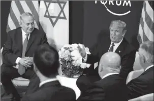  ?? The Associated Press ?? ELUSIVE GOAL: Israeli Prime Minister Benjamin Netanyahu looks on as President Donald Trump speaks on Jan. 28 during a meeting at the World Economic Forum in Davos. In the foreground from left are White House senior adviser Jared Kushner, National...