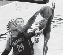  ?? RICH PEDRONCELL­I/AP ?? Sacramento Kings guard Buddy Hield, left, blocks the shot of Miami Heat guard Kendrick Nunn during the first half on Feb. 18.