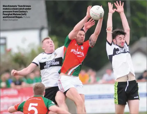  ?? Aidan Dullaghan Picture: ?? Glen Emmets’ Tom Grimes makes a clean catch under pressure from Cooley’s Fearghal Malone (left) and Emmet Rogan.