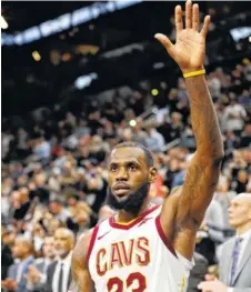  ?? THE ASSOCIATED PRESS ?? Cleveland Cavaliers forward LeBron James acknowledg­es cheering fans after he scored to reach the 30,000 milestone for his career.