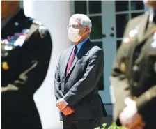  ?? AP PHOTO/ALEX BRANDON ?? Dr. Anthony Fauci, director of the National Institute of Allergy and Infectious Diseases, listens as President Donald Trump speaks about the coronaviru­s in the Rose Garden on May 15.