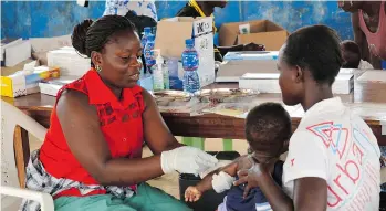  ?? ZOOM DOSSO/AFP/GETTY IMAGES ?? A child is vaccinated in a poor neighbourh­ood of Monrovia last month. The people of Monrovia’s Peace Island ghetto, refugees of civil war, face an even deadlier threat — the measles virus.