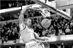  ??  ?? Terry Rozier #12 of the Boston Celtics dunks the winning basket during the 112-111 victory over the Indiana Pacers at Bankers Life Fieldhouse on December 18, 2017 in Indianapol­is, Indiana. - AFP photo