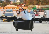  ?? Reuters ?? A journalist rides a drone controlled by inventor Kyxz Mendiola, during its unveiling in the province of Batangas, Philippine­s on Sunday.