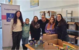  ?? ?? TeamAtlas members helping out with the packing of food items at the Foodbank Lifeline Foundation