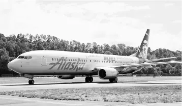  ?? — Reuters photo ?? An Alaska Airlines plane is pictured with a paint job to mark the centennial of The Boeing Company in Seattle, Washington.