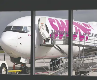  ?? TARA WALTON / THE CANADIAN PRESS ?? Swoop Airlines is weathering customer complaints after it was forced to cancel 23 flights during the past week.