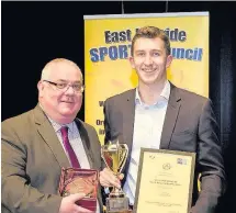  ??  ?? Track ace Greg Kelly receives the U18 prize from David Watson, left