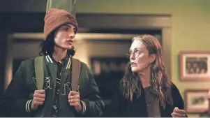  ?? KAREN KUEHN/A24 VIA AP ?? The missed connection­s between son, Finn Wolfhard, left, and mother Julianne Moore are the heart of the film, “When You Finish Saving The World.”