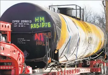  ?? GENE J. PUSKAR AP FILE ?? A tank car sits on a trailer as the cleanup of portions of a Norfolk Southern freight train that derailed Feb. 3 continues in East Palestine, Ohio. The train was carrying toxic chemicals.