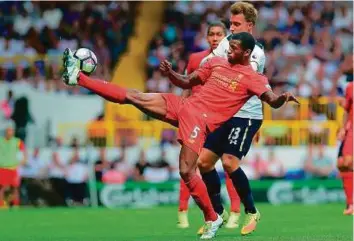  ?? Rex Features ?? Georginio Wijnaldum of Liverpool (centre), shielding the ball from Tottenham’s Christian Eriksen in the August fixture, is aware the Reds desperatel­y need to get back on track.