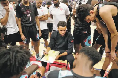  ?? Photos by Carlos Avila Gonzalez / The Chronicle ?? Above: Warriors guard Stephen Curry goes over a play with his team during a timeout in the game at the Stephen Curry SC30 Select Camp at Merritt College in Oakland. Right: Curry greets Jalen HoodSchifi­no, a playre from Charlotte, N.C., at the camp. It’s the sixth year of Curry’s camp, developed in conjunctio­n with Under Armour. Invited are top high school players from across the country with diverse background­s and skill sets.