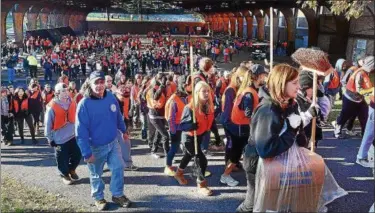  ?? DIGITAL FIRST MEDIA FILE PHOTO ?? Students and other volunteers leave The Hill School ice rink to start cleaning up Pottstown as part of the CARES program.