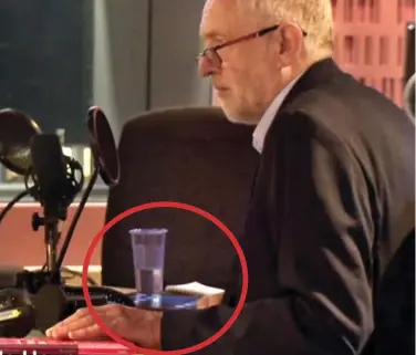  ??  ?? Caught out: Jeremy Corbyn reaches for his iPad in the studio