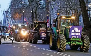  ?? PA ?? > Farmers taking part in a tractor ‘go-slow’ in central London on Monday