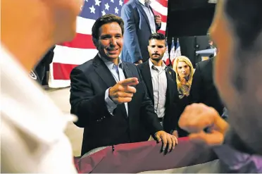  ?? CHARLIE NEIBERGALL/THE ASSOCIATED PRESS ?? Florida Gov. Ron DeSantis greets audience members during his first presidenti­al campaign event in Clive, Iowa.