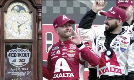  ?? AP photo ?? William Byron, center, celebrates with crew members in Victory Lane after receiving the trophy for winning the NASCAR Cup Series auto race at Martinsvil­le Speedway in Martinsvil­le, Va., on Sunday.