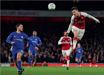  ?? AFP ?? Arsenal’s Laurent Koscielny ( right) in action in their English League Cup semi- final against Chelsea in London on Wednesday. Arsenal won 2- 1. —