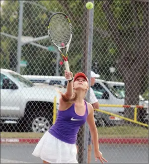 ?? MIKE BUSH/NEWS-SENTINEL ?? Above: Tokay No. 1 girls tennis player Rebecca Kostolanio­va serves the ball in Tuesday's TCAL home match. Left: Tokay No. 2 girls tennis player Jasmine Gill races toward the ball at the baseline.