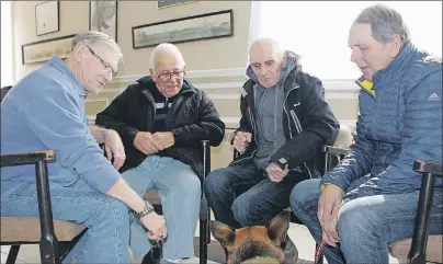  ?? MILLICENT MCKAY/TC MEDIA ?? Veterans Dennis Hopping, from left, John B. Perry, Brian Sutton and Austin McLin chat after Tuesday’s veteran peer support group in Summerside, while dog Myah rests nearby.