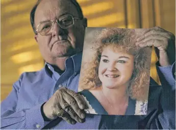  ?? CHARLIE RIEDEL/AP ?? Mortuary owner Brian Simmons holds a photo of his daughter Rhonda Ketchum, who died before Christmas of COVID-19. “My daughter went to the hospital, and we saw her once through the glass when they put her on the ventilator, and then we never saw her again until after she died.”