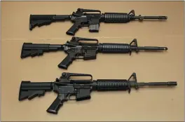  ?? RICH PEDRONCELL­I — THE ASSOCIATED PRESS FILE ?? Three variations of the AR-15 assault rifle are displayed at the California Department of Justice in Sacramento.