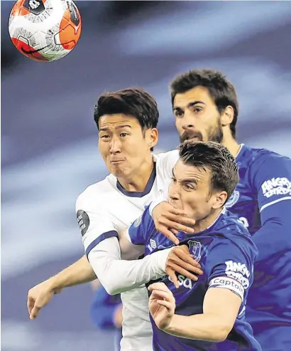  ?? REUTERS ?? Spurs get upper hand in arm wrestle: Tottenham’s Son Heung-min tussles with Everton’s Seamus Coleman during last night’s Premier League game. Tottenham won the game 1-0