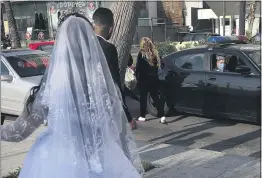  ?? HUSSEIN MALLA — THE ASSOCIATED PRESS FILE ?? On April 18, a policeman asks a bride and groom to leave the waterfront promenade in Beirut, Lebanon, where they had decided to take some pictures.