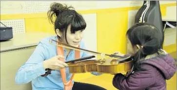  ?? Photograph­s from Assn. of Japanese Symphony Orchestras ?? CLASSICAL MUSIC is taught to Japanese students at a young age, like this little violin soloist of the future.