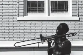  ?? THE COMMERCIAL APPEAL FILES ?? Sept. 16, 2017: Victor Sawyer, a trombonist for local band The Dead Soldiers, warms up his instrument outside of First Congregati­onal Church prior to his group’s afternoon performanc­e at the 30th annual Cooper-young Festival. The event was expected to draw an attendance of around 130,000 people.