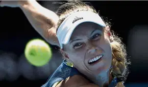  ?? — AP ?? One tough cookie: Denmark’s Caroline Wozniacki eyeing the ball to make a return to Belgium’s Elise Mertens during their semi-final match yesterday.