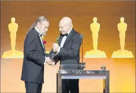  ?? Valerie Macon AFP / Getty Images ?? ACTOR Patrick Stewart, right, delivers a special honor to visual effects technologi­st Jonathan Erland on Saturday night at the film academy’s Sci-Tech Awards.