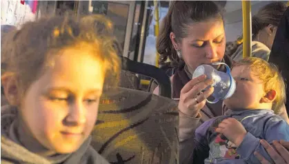  ?? Photo / AP ?? Anna, 29, and her son Ivan, 1, who fled from the Azovstal steel plant in Mariupol, arrive in Zaporizhzh­ia.