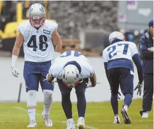  ?? STAFF PHOTO BY NICOLAUS CZARNECKI ?? LIMBER UP: Tight end Jacob Hollister (48) stretches out at the start of yesterday’s practice in Foxboro.