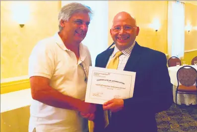  ?? Contribute­d photo / ?? Chief of Litchfield Volunteer Ambulance Service John Pudlinski receives appreciati­on from Charlotte Hungerford Hospital EMS and Emergency Management Coordinato­r Paul Rabeuf. CHH recognized the local EMS agencies at their annual EMS Appreciati­on Dinner...