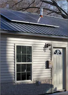  ?? Arkansas Democrat-Gazette/JOHN SYKES JR. ?? Solar panels on the roof of Raymond Donaldson’s new house will help keep his electric bills extremely low. The house was built as a partnershi­p between Habitat for Humanity of Central Arkansas and the U.S. Green Building Council.