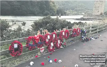  ?? PACEMAKER ?? Wreaths and floral tributes to soldiers killed at Narrow Water were destroyeda­gain