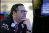  ?? RICHARD DREW — THE ASSOCIATED PRESS FILE ?? Specialist Gregg Maloney works on the floor of the New York Stock Exchange.Banks surged Wednesday following strong results from a slew of financial companies, and U.S. stock indexes finished broadly higher.