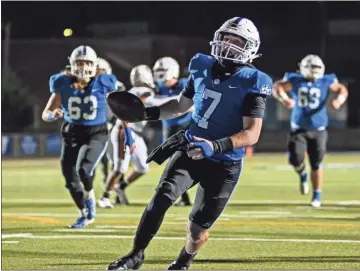  ?? Courtney Couey, Ringgold Tiger Shots ?? Ringgold quarterbac­k Mason Parker glides into the end zone to complete a 15-yard touchdown run in the first quarter of their home playoff game against Hart County. Parker had over 200 yards of total offense in a 30-21 win over the Bulldogs.