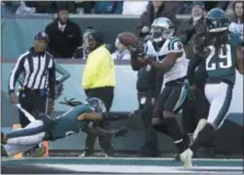  ?? MATT ROURKE — THE ASSOCIATED PRESS ?? Carolina Panthers wide receiver Devin Funchess, center, catches a touchdown pass from quarterbac­k Cam Newton, not pictured, as Philadelph­ia Eagles cornerback Ronald Darby, left, and cornerback Avonte Maddox (29) defend during the second half of an NFL football game Sunday.