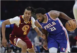  ?? DAVID DERMER — THE ASSOCIATED PRESS ?? Philadelph­ia 76ers center Joel Embiid drives against Cleveland Cavaliers center Moses Brown in the second half of an NBA basketball game, Sunday in Cleveland.