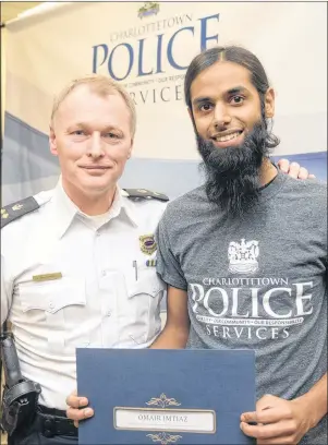  ?? MITCH MACDONALD/THE GUARDIAN ?? Omair Imtiaz, right, receives a certificat­e from Charlottet­own deputy police chief Brad MacConnell after graduating from the Citizen Police Academy. Imtiaz described the academy as an eye-opening experience that gave him a greater appreciati­on for the...