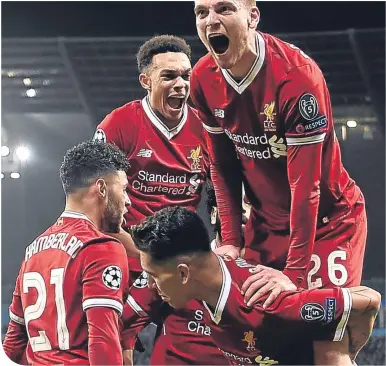  ??  ?? Andy Robertson celebrates grabbing a Champions League semi-final spot in midweek