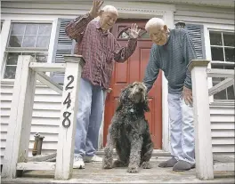  ?? STEPHAN SAVOIA — THE ASSOCIATED PRESS ?? In this photo Richard Perkins, right, and Robert Maurais stand outside their home in Ogunquit, Maine. Perkins called Mr. Trump’s proposed eliminatio­n of heating aid “cruel.”