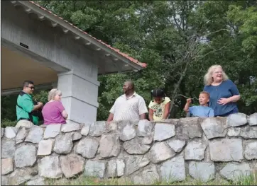  ?? The Sentinel-Record/Richard Rasmussen ?? NATIONAL PARK REOPENING: Visitors enjoy the view from a Hot Springs Mountain overlook Friday. As part of a phased reopening, the restrooms at the top of Hot Springs Mountain have reopened.